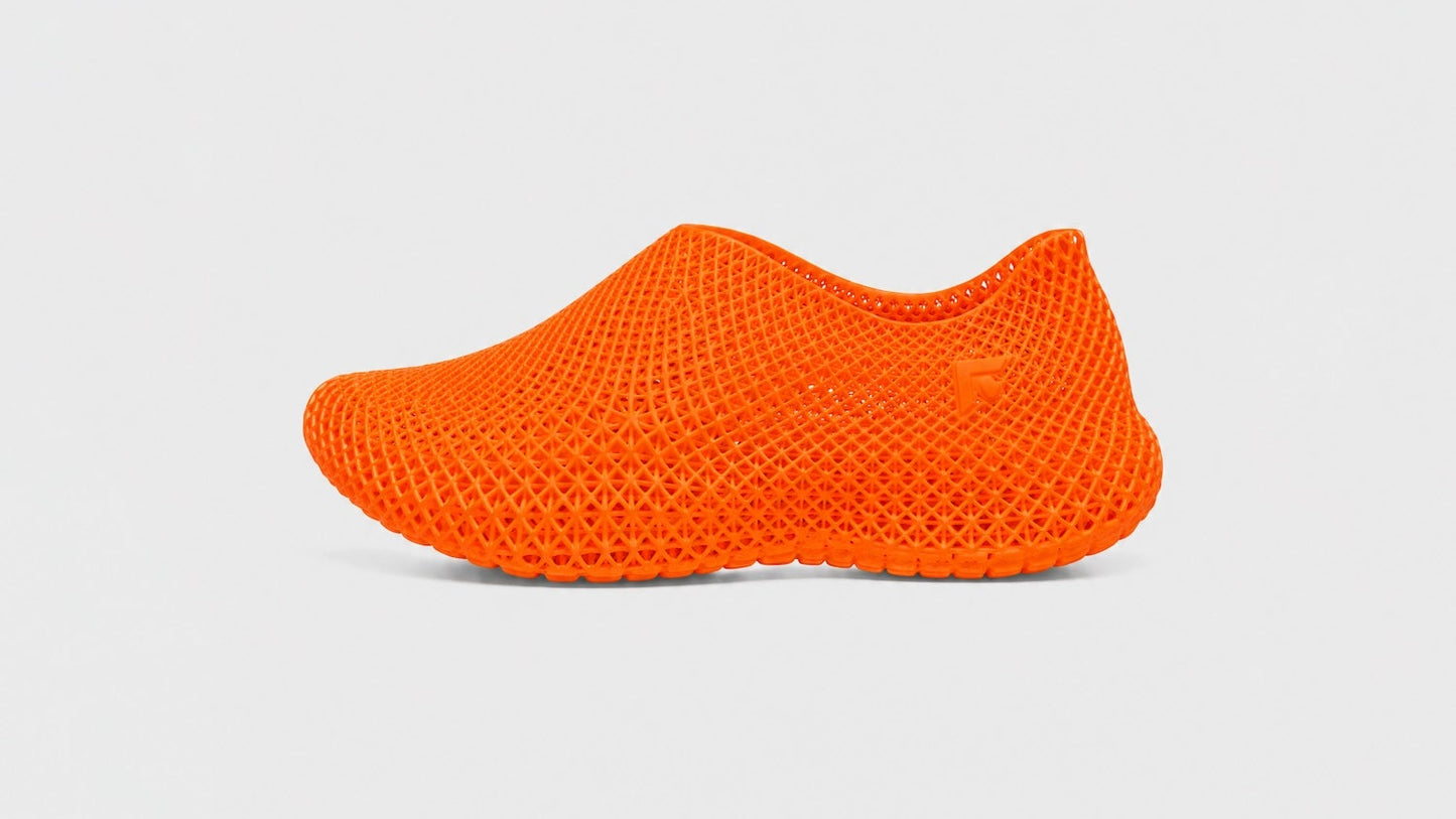 Orange knit shoe on a light gray background