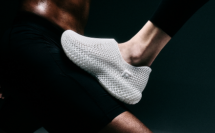 White sock on a person's foot against a dark background